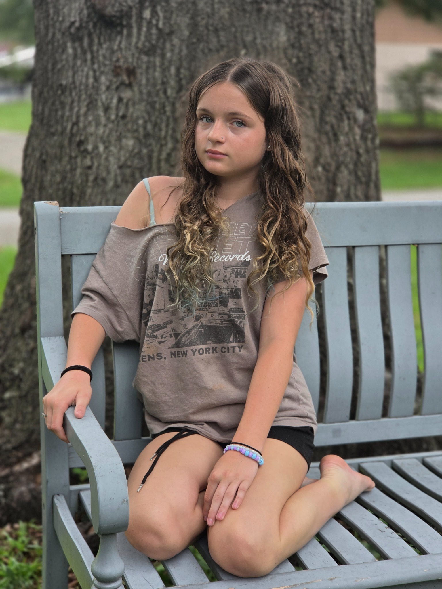 Full-length portrait of Caitlyn Helms seated outdoors