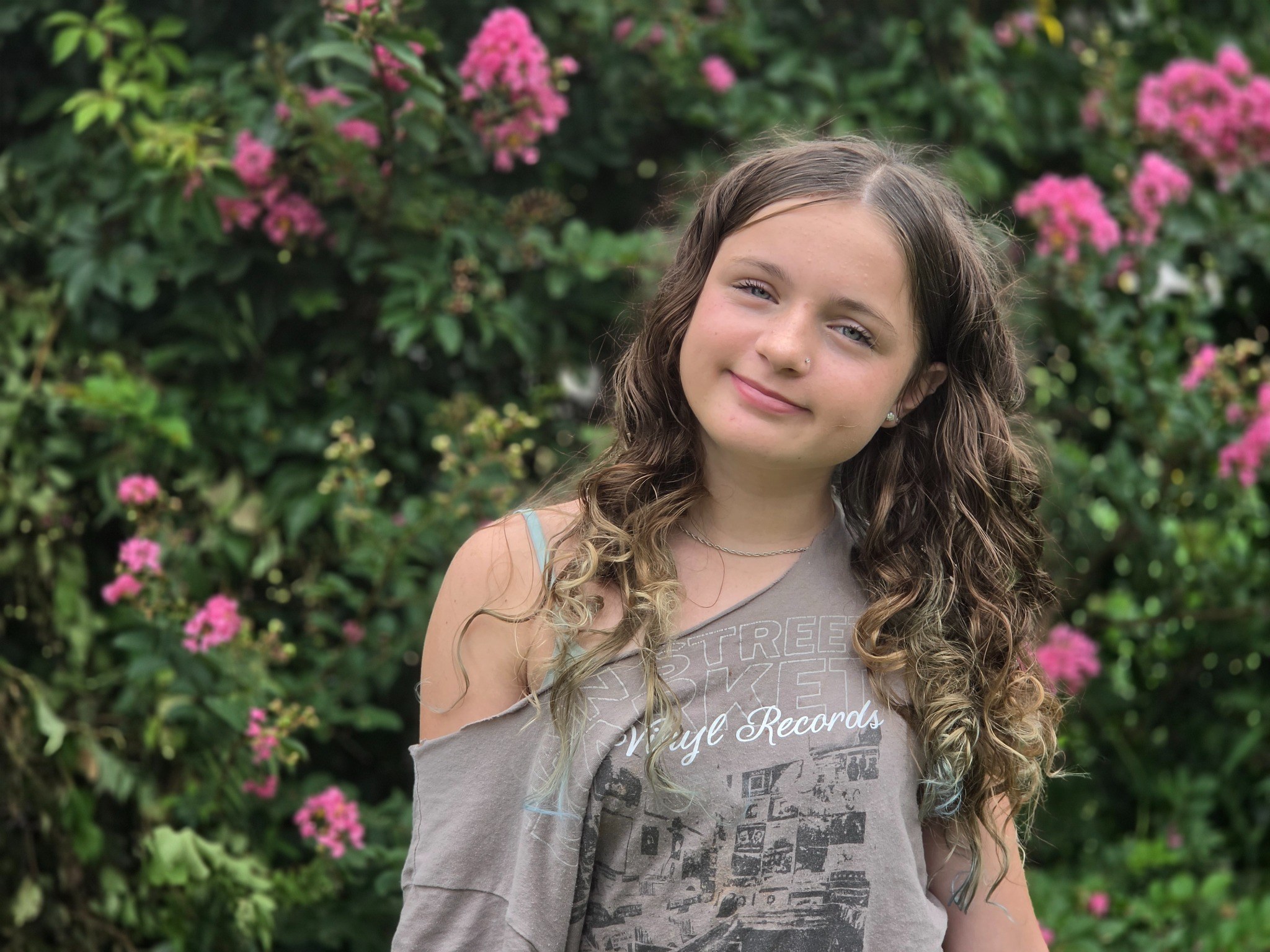 Caitlyn Helms standing in front of flowers