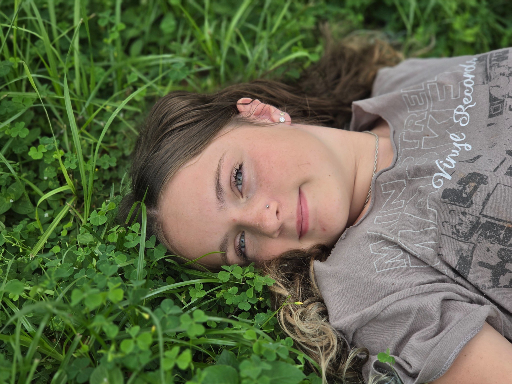 Caitlyn Helms lying in the grass