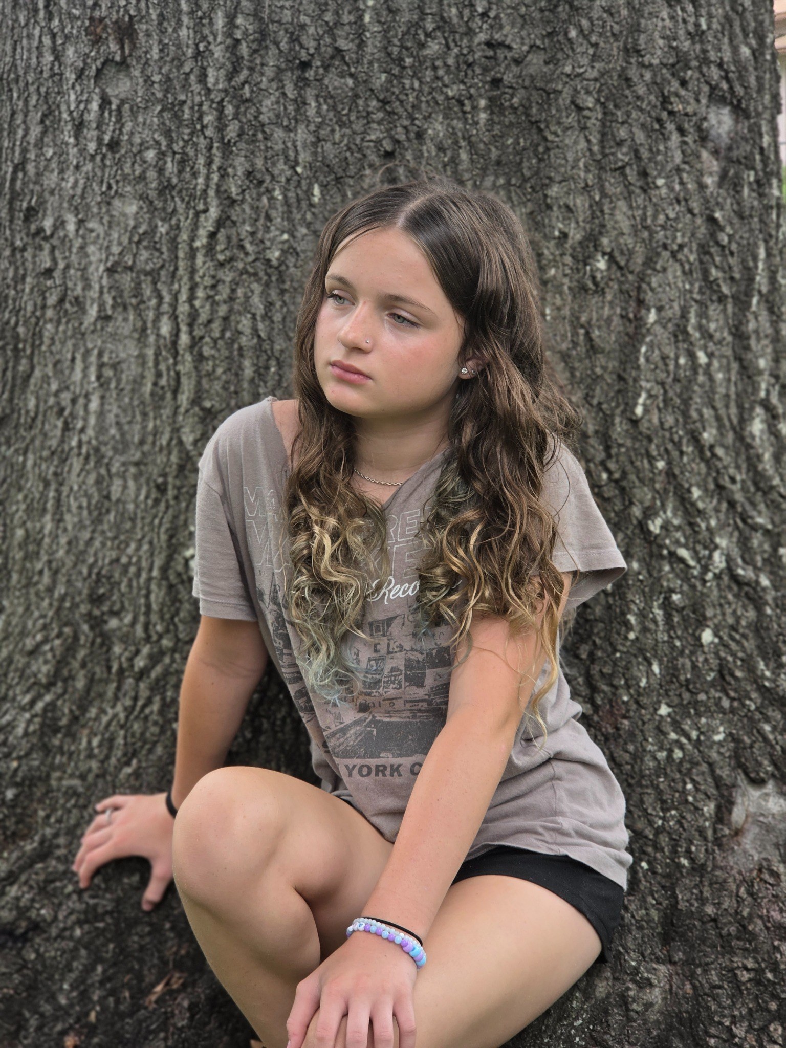 Caitlyn Helms posed against a tree